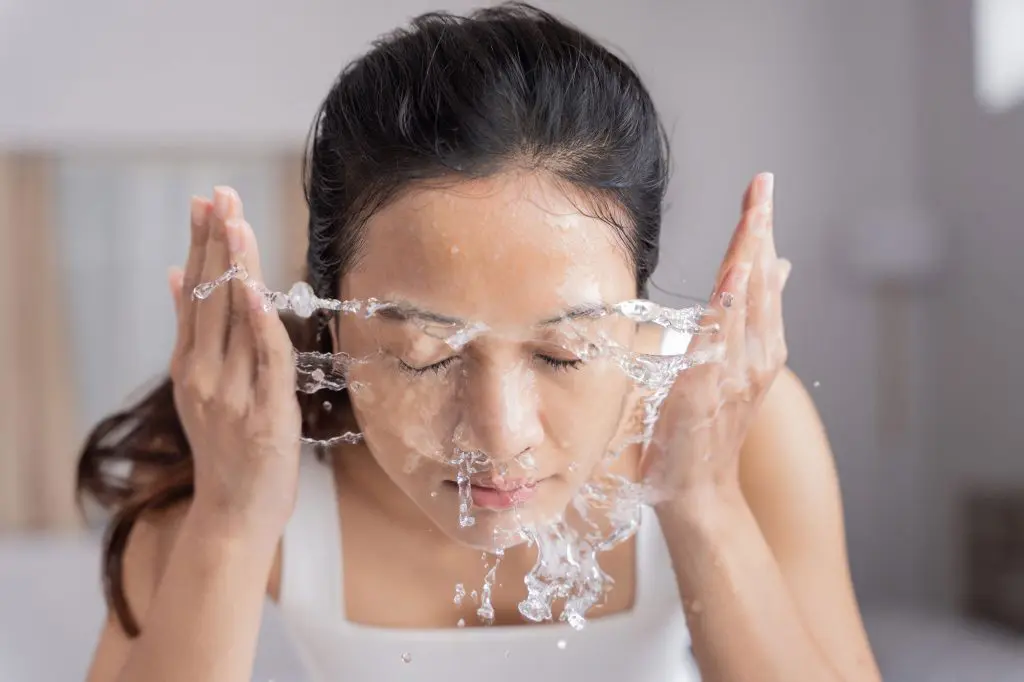 Woman washing her face before a chemical exfoliation session