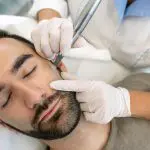 micro needling work on a patient. Young Man in Beauty Clinic Having Dermatude Meta Therapy, Rejuvenating Treatment by Cosmetologist. skin treatments for men